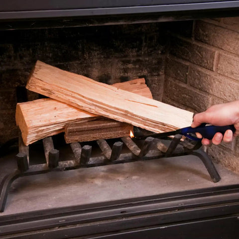 Hand lighting firewood in fireplace using Instant Start Firelighters 40 Count Case For Easy Ignition In Fireplaces Grills And Fire Pits