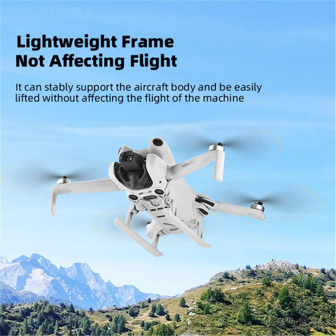 Mini 4 Pro Foldable Sled Landing Gear Extension Kit for DJI drone in flight, showcasing lightweight design against mountain background