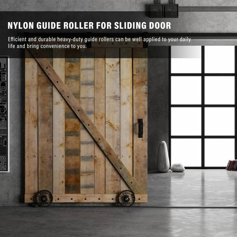 Rustic sliding wooden door with nylon guide rollers installed for smooth operation in industrial interior setting.