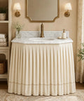 Peel And Stick Under Sink Skirt Cover In Crisp White Pleated Cotton conceals plumbing under a stylish vanity sink.