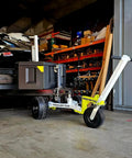 Monster Tug Off-Road Trailer Dolly Moves Boat, RV, Or Utility Trailer With Ease On Sand, Dirt, Gravel, Concrete Hard Surfaces Heavy Metal Frame Manual Mover No Motor Needed Adjustable Ball Mount For Any Tow in garage with black utility trailer.