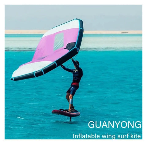 Person using pink and white Inflatable Windsurfing Wing For Windsurfing Wing Foil And Handheld Kite Surfing For Surf And Snow Skiing.