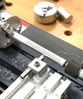 EssSthmy Mini Metal Lathe Machine, 36W 20000 RPM Benchtop Lathe with workpiece in focus on a workshop table.