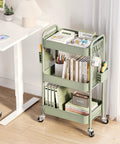Three Tier Rolling Cart Storage Organizer with Metal Wheels Pegboard Hooks and Bins for Bathroom Kitchen Office Nursery and Craft Rooms positioned beside a desk