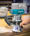 18V LXT Cordless Compact Router with Brushless Motor 1/4 In Collet cutting wood on a workbench, showcasing precise performance