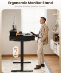 Man using Electric Standing Desk With Three Wooden Drawers, 48 Inch Wide Height Adjustable Sit Stand Desk With Built In Power Outlets And LED Lights, Black Monitor Stand For Your Home Office, Study And Creative Workstations.