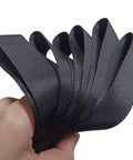 Hand holding Beefy Soft Loop Tie Down Straps Pack Of 6, 1500 Lb Load Capacity And 4500 Lb Break Strength, 12 By 1 Inch Heavy Duty Nylon Tie Downs