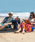 Couple relaxing on blue 2 Pack Lightweight Low Beach Chairs With Breathable Mesh Back, Folding Portable Sand Chairs With Cup Holder on beach