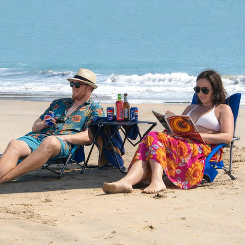 Couple relaxing on blue 2 Pack Lightweight Low Beach Chairs With Breathable Mesh Back, Folding Portable Sand Chairs With Cup Holder on beach