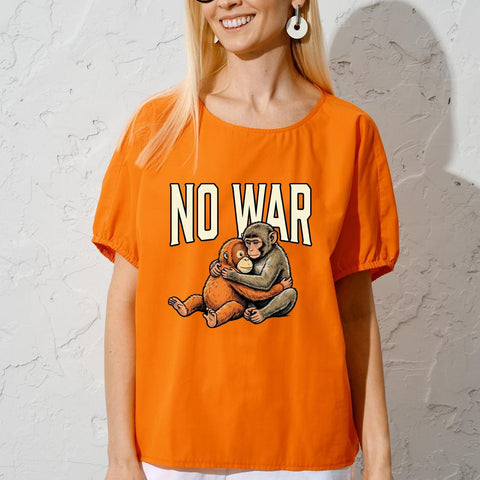 Woman wearing orange tee with 'NO WAR' text and hugging monkeys from Dope Antiwar DTF Transfers Set For DIY Tees Six Pack Monkey Punchs Antiwar Collection Ready To Press 7x7 Washable Iron On Vinyl Decals For Custom T Shirts And Everyday Streetwear Vibe