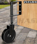 Heavy Duty 5 Inch Spring Loaded Gate Caster Wheel Packs Rock Solid Shock Absorption And Smooth 360 Swivel Glide For Outdoor Wooden Fence And Steel Tube Gates No Stress Rolling Up To 220 Pound In Matte Black mounted on a wooden gate.