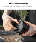 Person attaching 4 In 1 Center Pinch Lens Cap Kit to 49mm camera lens, easy snap on protection.
