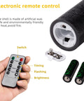 Close-up of remote and batteries for Set Of 9 Black Textured Flameless LED Real Wax Pillar Candles With Remote Control And Timer