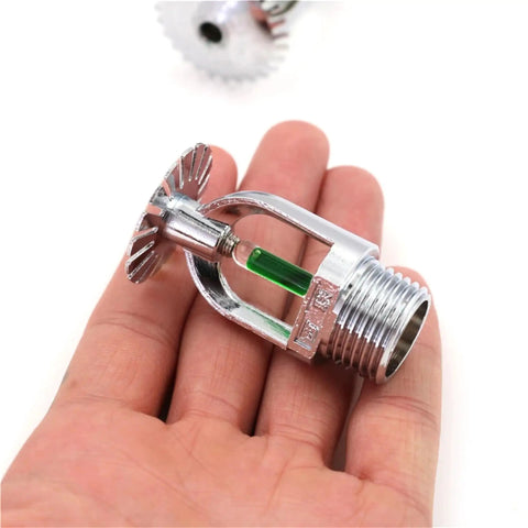 Top Shelf Five Pack Pendent Fire Sprinkler Heads With 1/2 Inch Thread 199 Degree Fahrenheit Rated Green Glass Bulbs And Boss Level Nickel Finish Including Dead Simple Setup Wrench For Straight Up Building Safety held in hand.
