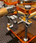 Close-up of the Straight Up Espresso Tamping Station For Home Baristas showing the 58mm acrylic portafilter holder and steel support.