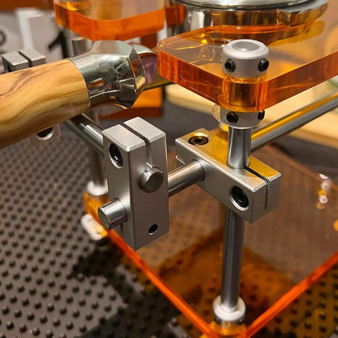 Close-up of the Straight Up Espresso Tamping Station For Home Baristas showing the 58mm acrylic portafilter holder and steel support.