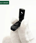 Gloved hand holding black corner bracket from 30 Sets 2020 Aluminum Extrusion Hardware Connectors With Screws And Wrench