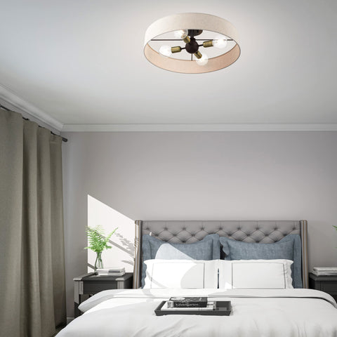 Four Light Bronze Semi Flush Mount With Antique Brass Accents And Oatmeal Fabric Shade in a bedroom setting