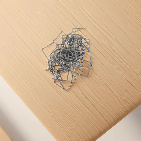 High Performance Hot Plastic Bumper Repair Welding Staples For Auto Body Work With Precision 0.8mm Rods piled on a wooden surface.