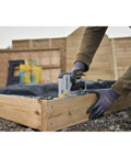 Heavy Duty Staple And Brad Gun for fast, precise fastening in woodworking and upholstery projects being used on wood
