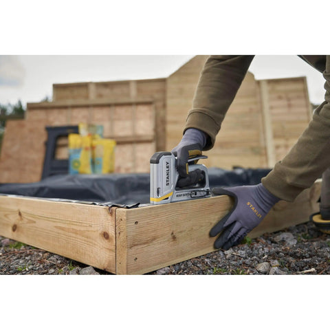 Heavy Duty Staple And Brad Gun for fast, precise fastening in woodworking and upholstery projects being used on wood