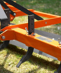 Close-up of Heavy Duty 72 Inch Tractor Land Leveler Scraper Grader Attachment with adjustable shanks on grassy terrain