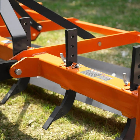 Close-up of Heavy Duty 72 Inch Tractor Land Leveler Scraper Grader Attachment with adjustable shanks on grassy terrain