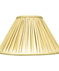Empire Gather Pleat Lamp Shade in Antique Gold Silk Shantung With Off White Lining, viewed from the front, showcasing pleats and texture.