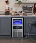 Rock Solid Commercial Ice Maker, Drip Free Self Cleaning LED Interface With Up To 130 Lbs Daily Production And Super Roomy 30 Lb Storage Bin, Undercounter Stainless Steel Gear For Home Bars in a modern kitchen.