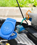 Porsche Cayenne Windshield Washer Fluid Cap Replacement 3Q0955455 in use, blue cap open, fluid pouring, engine bay view