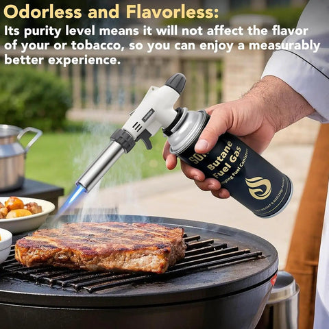 Person using butane gas torch on steak; part of All In One Camping Stove And Fuel Kit With Four Butane Canisters, Portable Outdoor Stove.