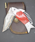 Damascus Steel Folding Knife With Ladder Pattern Blade And Copper Fish Style Handle displayed with leather sheath.