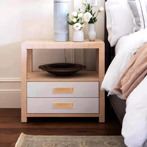 Nightstand with two drawers and gold handles in a bedroom setting