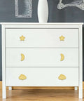 Standout Six Piece Set Of Bright Yellow Ceramic Cabinet Knobs on a white dresser with star, moon, and cloud shapes.