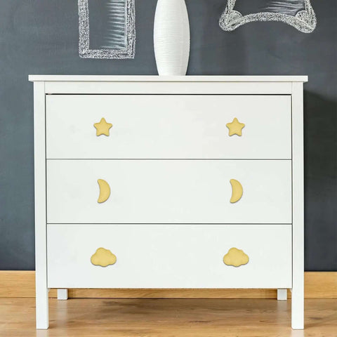 Standout Six Piece Set Of Bright Yellow Ceramic Cabinet Knobs on a white dresser with star, moon, and cloud shapes.