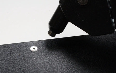 Size Forty Four Button Head Blind Rivets One Eighth Inch Diameter Three Sixteenths To Quarter Inch Grip Range Three Oh Four Stainless Steel Marine Grade Heavy Duty Fasteners in use with a rivet gun.