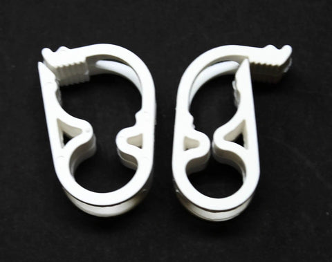 Two white Seven Sixteenth Inch Tubing Siphon Hose Shut Off Pinch Clamp With Seven Position Ratcheted Flow Control on black background