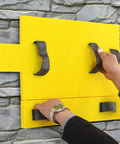Person using Polyurethane Concrete Stamp Mat 19.69 By 11.81 Inches, with DIY friendly seamless texture for outdoor decor on stone wall.