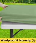 Waterproof Picnic Table Cover With Bench Covers for 6 Ft Rectangular Tables being placed, showing elastic fit and windproof design.