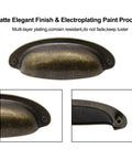 Close-up of vintage farmhouse cup pull handle in flat bronze showing matte finish and detailing.