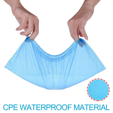 Hands stretching a blue shoe cover made from CPE material, showcasing durability. Disposable Shoe Covers One Size Fits All Super Durable CPE Material Waterproof Non Slip Dust Proof Boot Covers For Floors And Carpets Blue 100 Pack 50 Pairs Thick Tear Resistant Pro Grade.