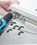 Using a power drill with 30 Pack Hidden Furniture Connectors And Adjustable Cabinet Fastener Brackets For Wardrobes And Sofas.