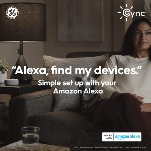 Woman sitting on sofa using Alexa with Cync Smart Home Starter Kit With Color Changing LED Bulb And Wireless Dimmer Switch