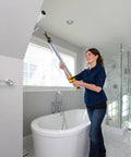 Woman using EZ Roller With Long Reach Handle Holds 22 Oz In The Handle Inner Fed Paint Roller Cuts Mess And Paints Interior Walls