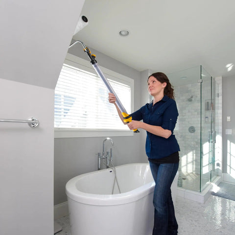 Woman using EZ Roller With Long Reach Handle Holds 22 Oz In The Handle Inner Fed Paint Roller Cuts Mess And Paints Interior Walls