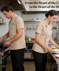 Premium Heavy Duty Cotton Blend Custom Embroidered Short Sleeve Chef Jacket For Cooks in a busy kitchen preparing dishes.