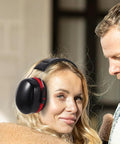 Kick Loud Noise To The Curb With Double Layer Over Ear Earmuffs designed for construction and mowing, black with red trim.