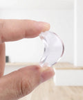 Hand holding 16 Pack Non Adhesive Glass Tabletop Gripper Dots 25x3mm Transparent Rubber Suction Cushions