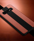 Black and brown textured phone case on leather background