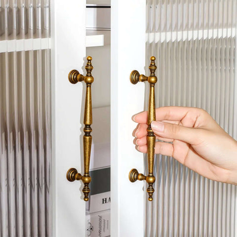Hand holding super stylish vintage antique brass cabinet pull with 5 inch hole centers on glass door. Get The Look You Want With These
